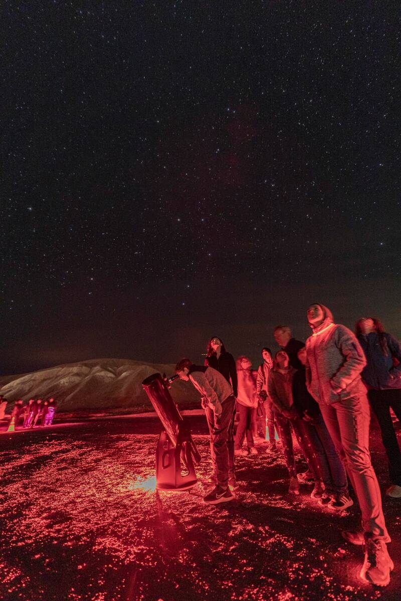 National Park Service Visitors take in the stars while waiting to look through a telescope.