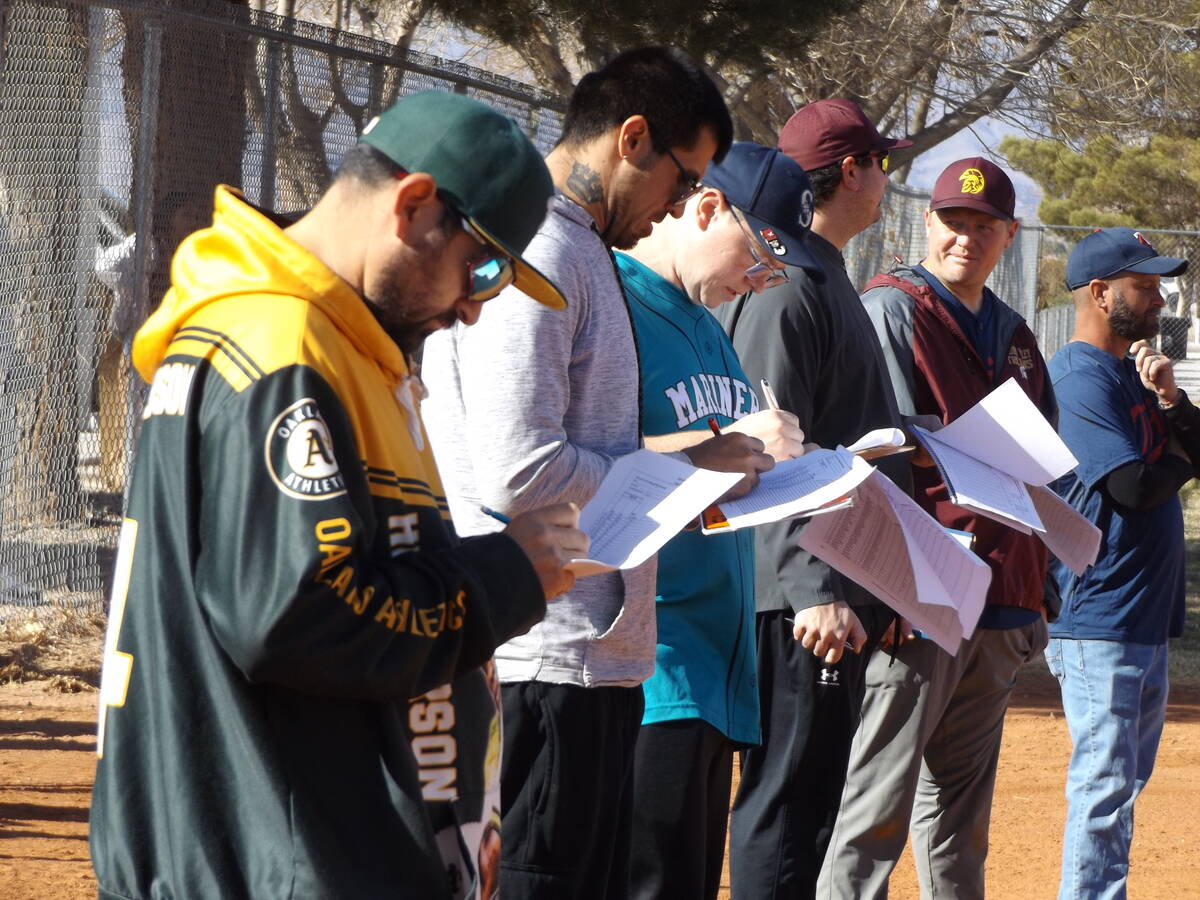 Charlotte Uyeno/Pahrump Valley Times Pahrump Valley Little Leaguer coaches review their scoreca ...