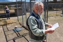 Karl Mitchell reads a piece of paper left behind by Nye County Sheriff’s Office at his P ...