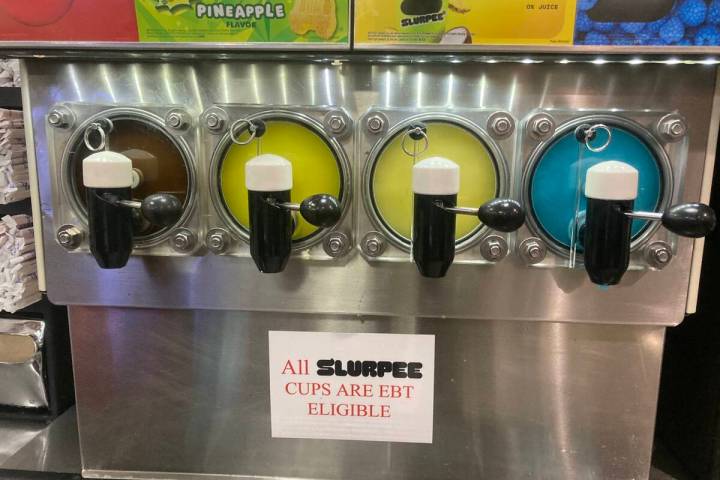 A sign below a 7-Eleven Slurpee machine states the sugary treat is eligible for EBT usage in He ...