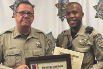 Nye County Sheriff's Office Sheriff Joe McGill, left, presents a special life-saving certificat ...