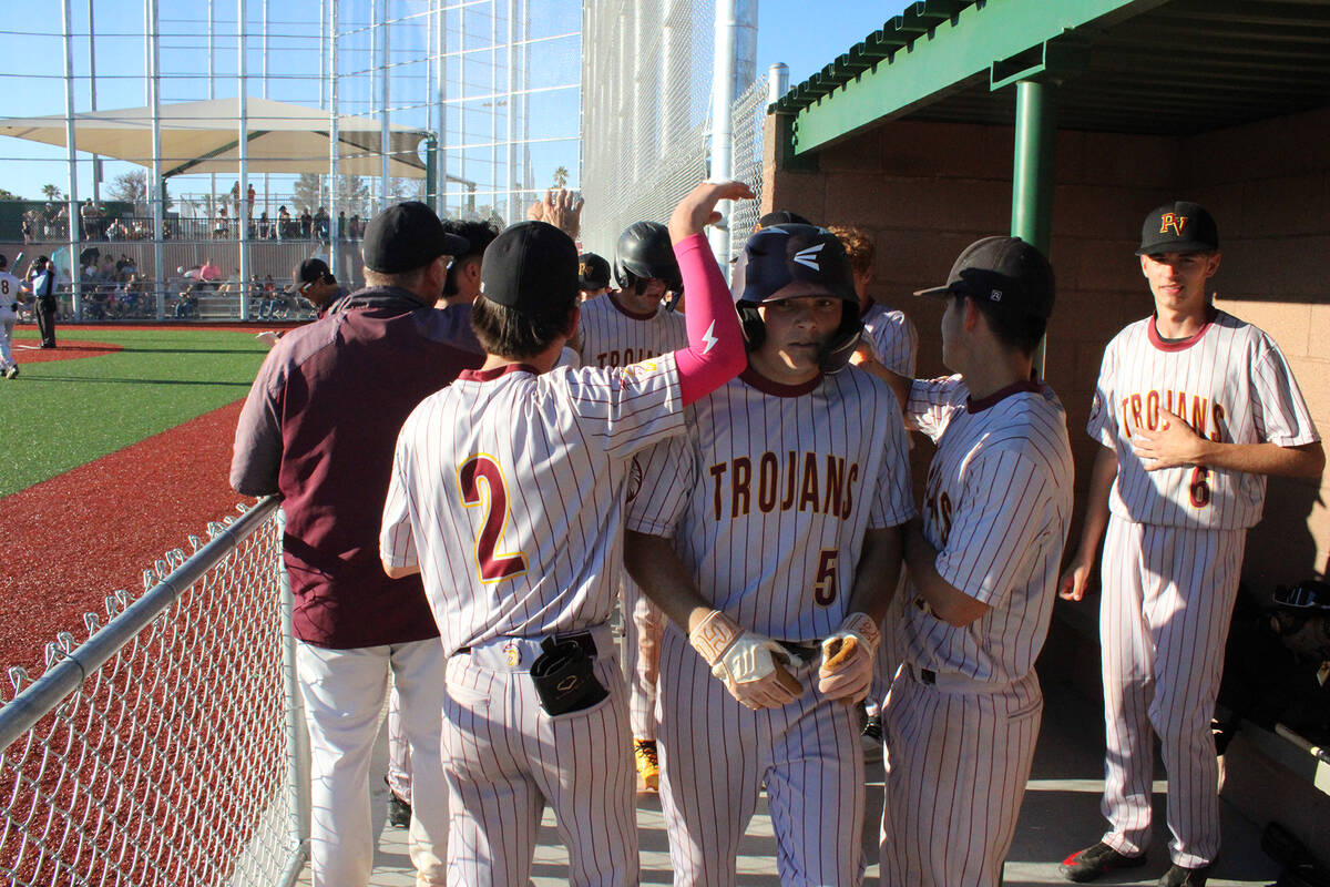 Jacob Powers/Pahrump Valley Times Trojans Aaron Rily is celebrated following scoring a run agai ...