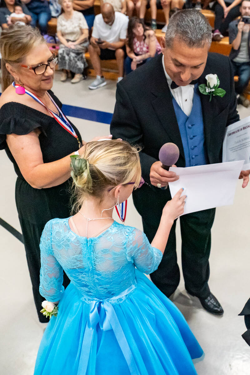 John Clausen/Pahrump Valley Times A student (C) receives her certificate and medal from LaPoint ...