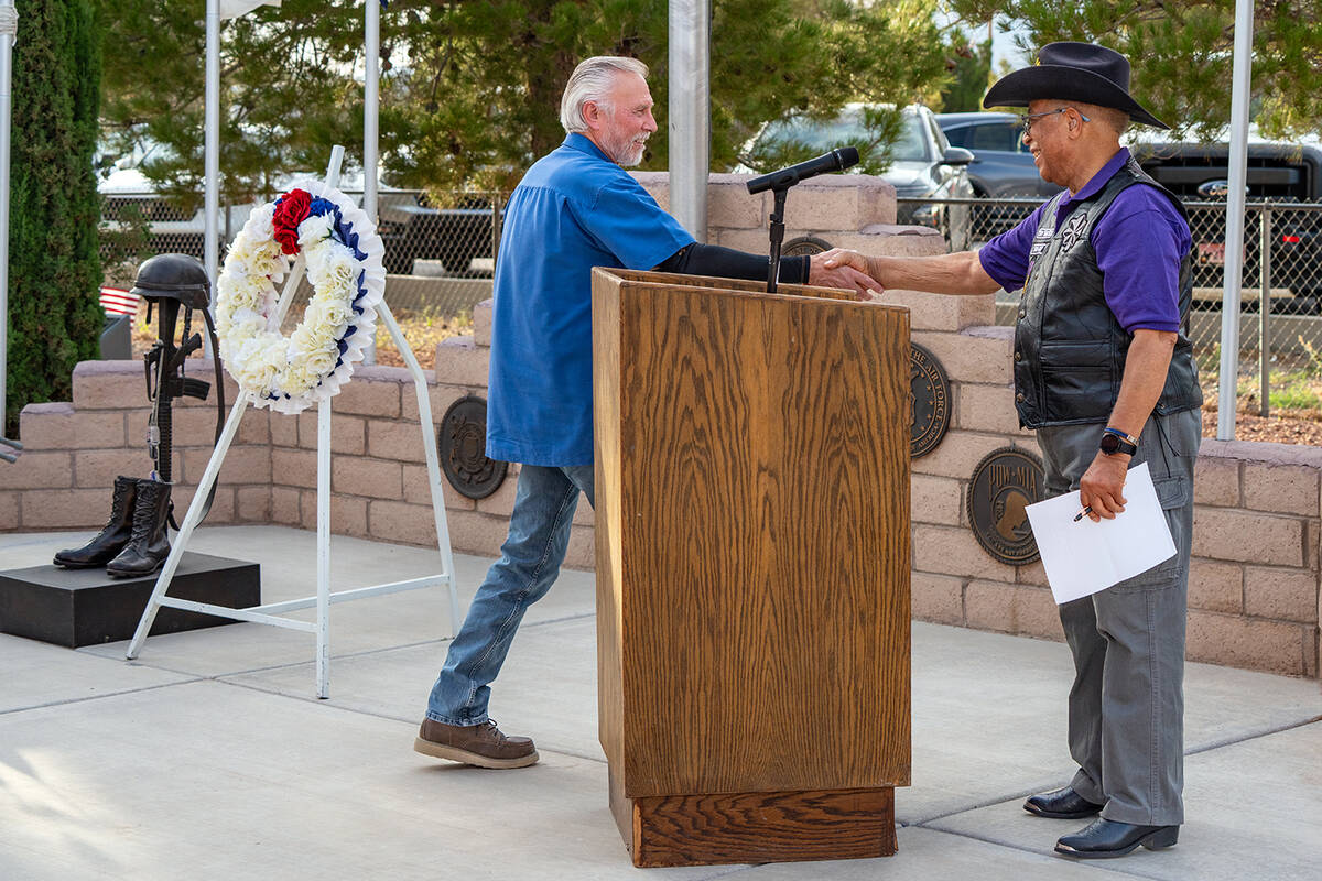 John Clausen/Pahrump Valley Times Dr. Tom Waters greets fellow veteran Frank Carbone with a han ...