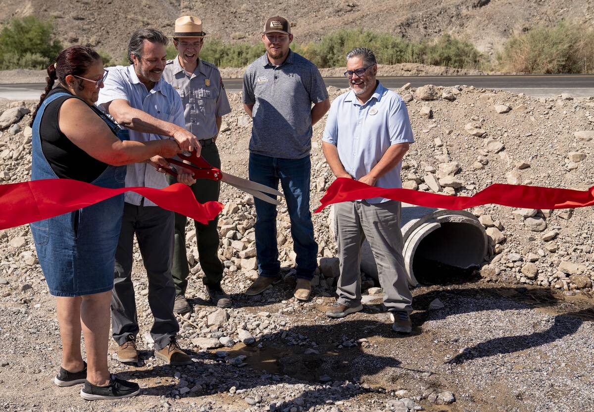 Mandi Campbell (Timbisha Shoshone Tribe) and Bryan Winzenread (Caltrans District 9) cut a cerem ...