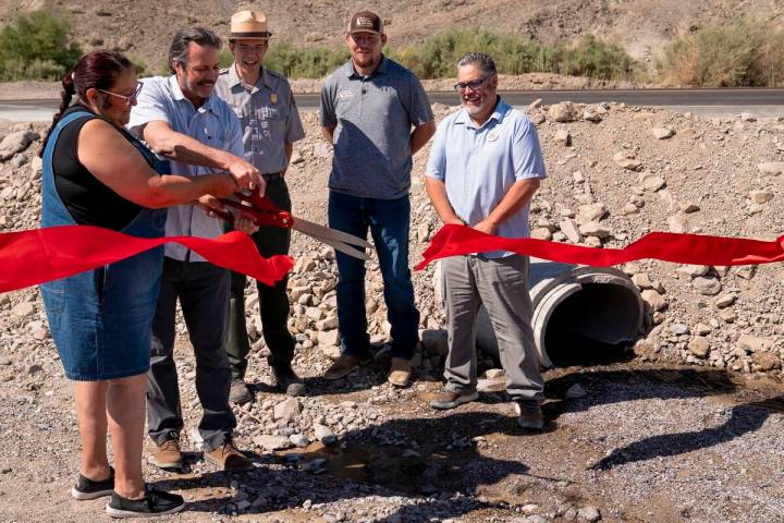 Mandi Campbell (Timbisha Shoshone Tribe) and Bryan Winzenread (Caltrans District 9) cut a cerem ...