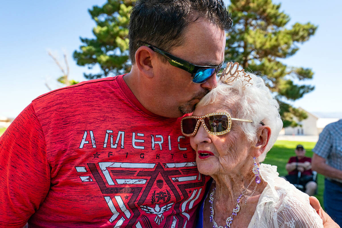 One of B.J. Hetrick-Irwin's many family members bestows a kiss upon the matriarch of five gener ...