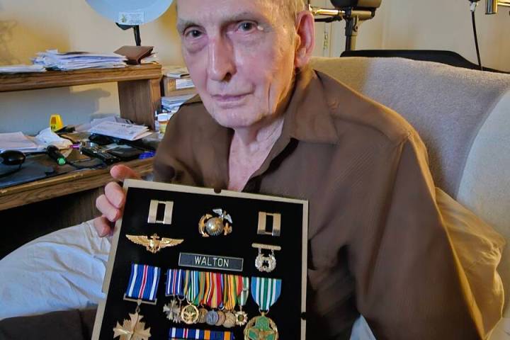 Walton displays the medals he earned as a helicopter pilot during the Vietnam War. (Photo court ...