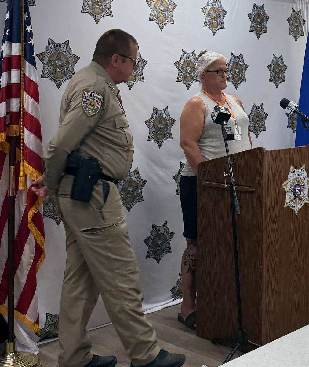 Mari Ausiello, mother of shooting victim Joey Perry, addresses the media as Sheriff Joe McGill ...