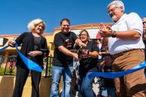 TJ and Nancy Thedinga (center) both cut the ribbon at their grand opening, flanked by Jenney Sa ...