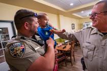 Deputy Michael Karr (l) and his son Michael Jr. join Sheriff Joe McGill (r) for a breakfast wit ...