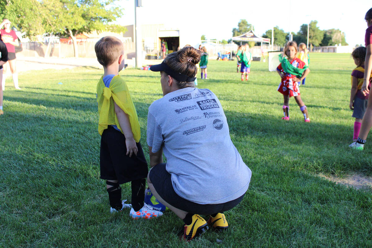 Pahrump Valley High School varsity girls soccer head coach Amy Carlson talks to a young soccer ...