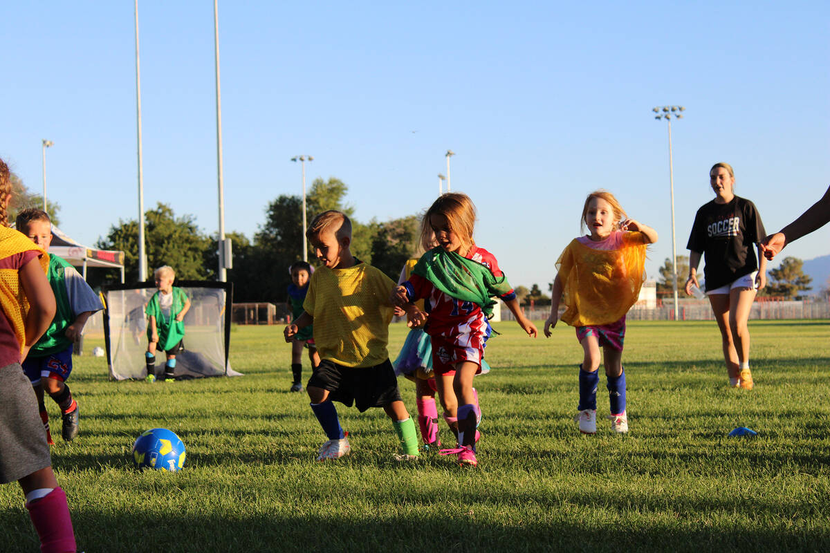 Youth soccer players try to control the ball during a scrimmage in camp held at Petrack Park. ( ...