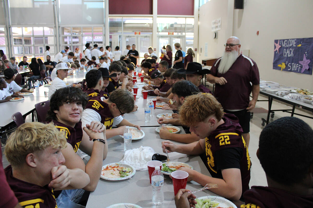Members of the Pahrump Valley High School Football team dig in on some spaghetti made by Leo Bl ...