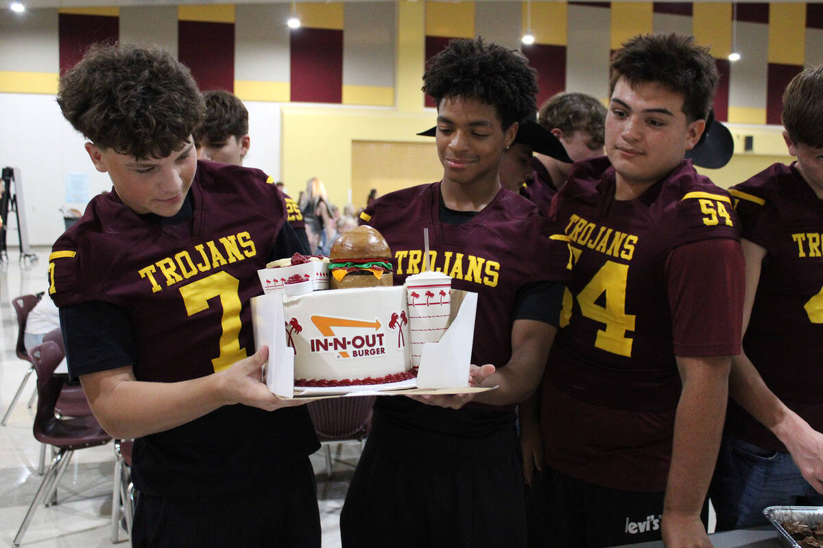 PVHS Football players Ryan Hamlin, Angel Ware and Sebastian Ferrer hold up an In-N-Out Burger-i ...