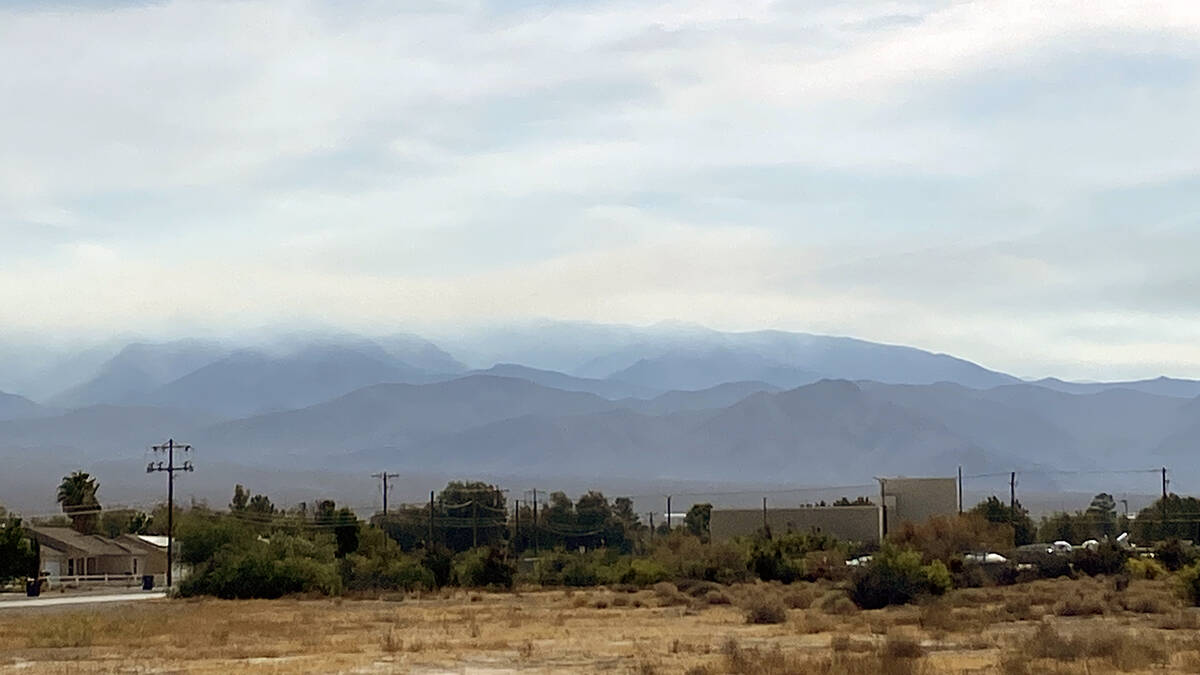 The Spring Mountains are usually starkly visible from the Pahrump Valley but wildfire smoke has ...