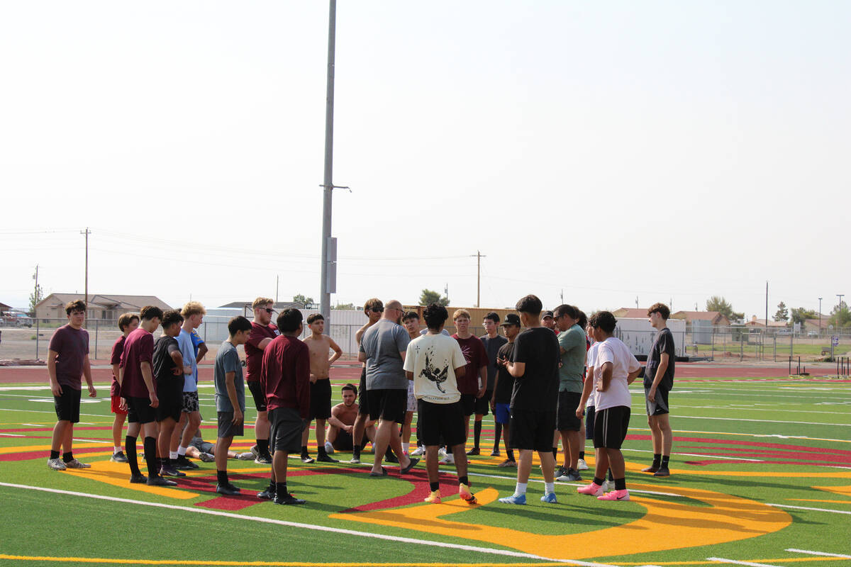 The Pahrump Valley High School boys soccer team rallies around head coach Andrew Norton during ...