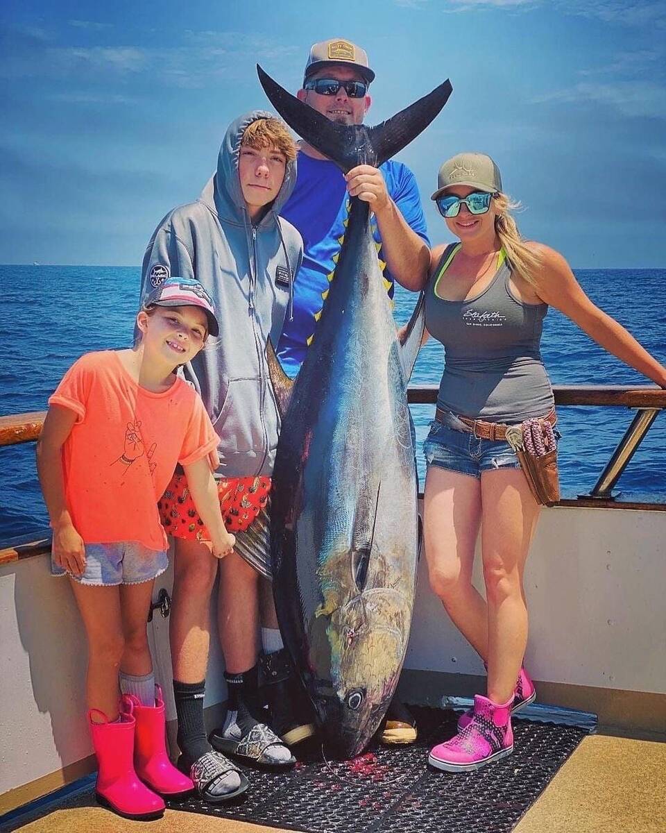 The prize for the biggest tuna of the day went to Maggie, who needed help showing it off. (Spec ...