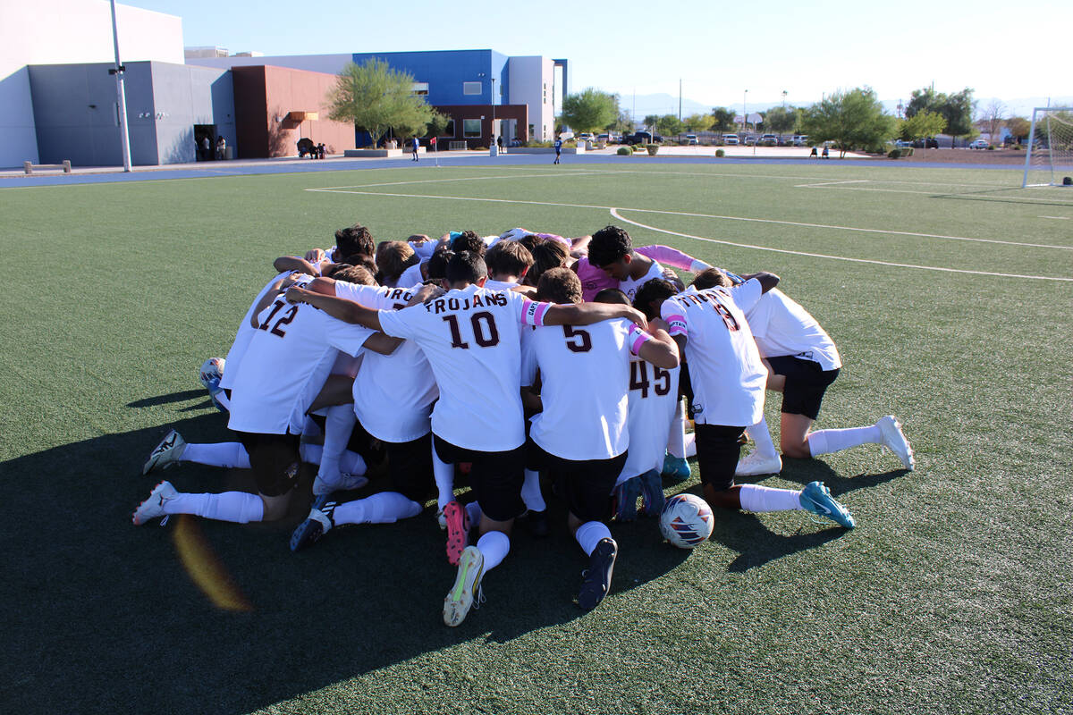 The Pahrump Valley High School boys varsity soccer team gathers for a team prayer before taking ...