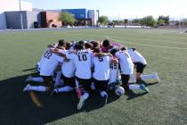 The Pahrump Valley High School boys varsity soccer team gathers for a team prayer before taking ...