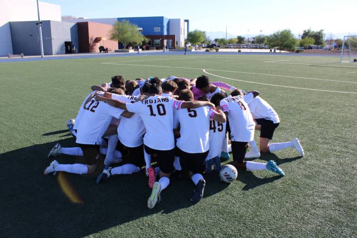 The Pahrump Valley High School boys varsity soccer team gathers for a team prayer before taking ...