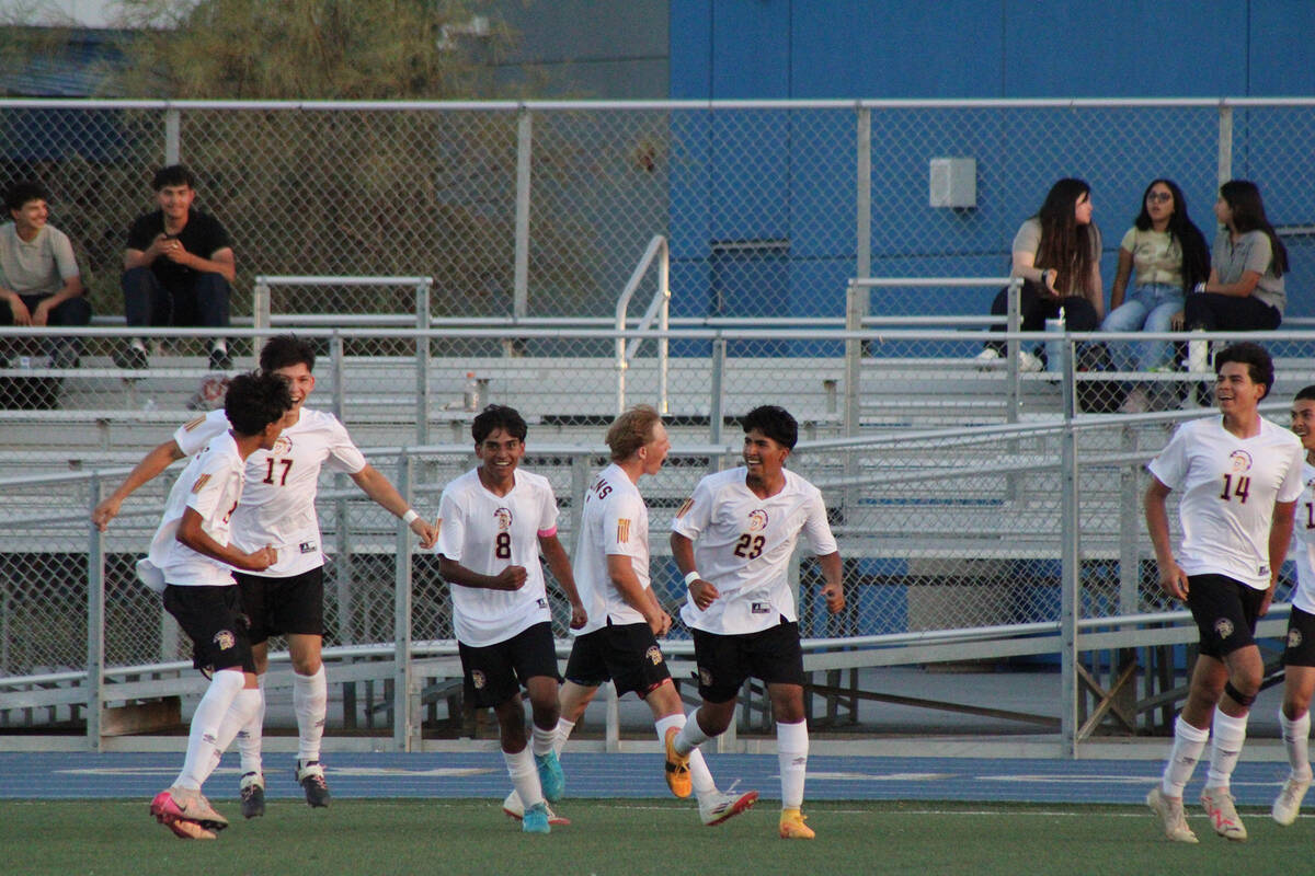 Members of the Pahrump Valley Varsity men's soccer program celebrate after holding Cristo Rey S ...