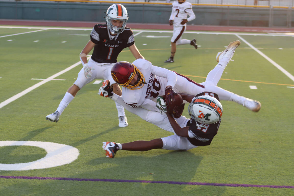 Pahrump Valley High School football player Luke Gavenda tries to secure the ball against a Moja ...