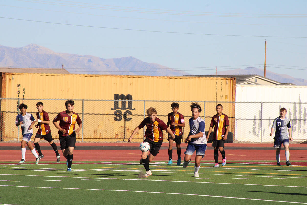Pahrump Valley High School varsity boys soccer junior midfielder TC Hone goes after control of ...