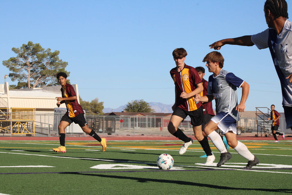Pahrump Valley High School boys soccer junior midfielder Samuel Mendoza guards The Meadows soph ...