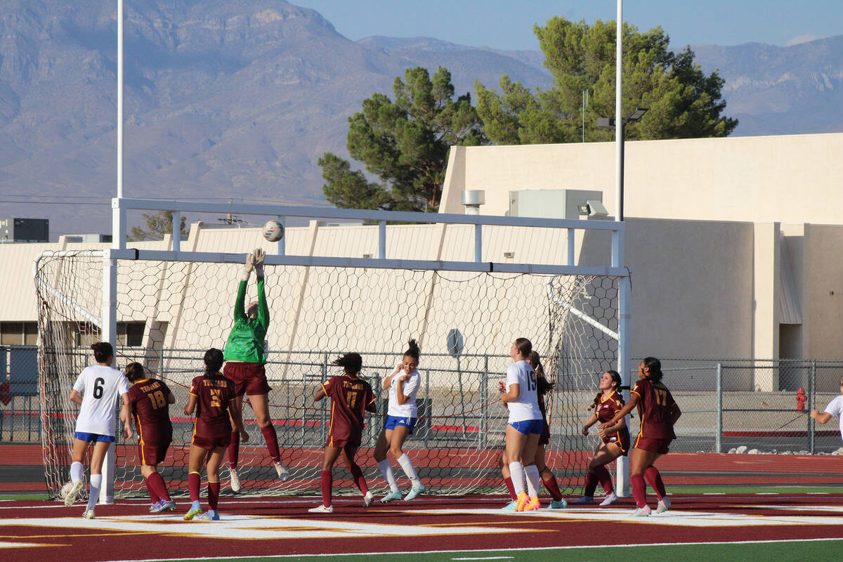 Pahrump Valley High School girls soccer senior goalkeeper Julie Briggs makes a save attempt in ...