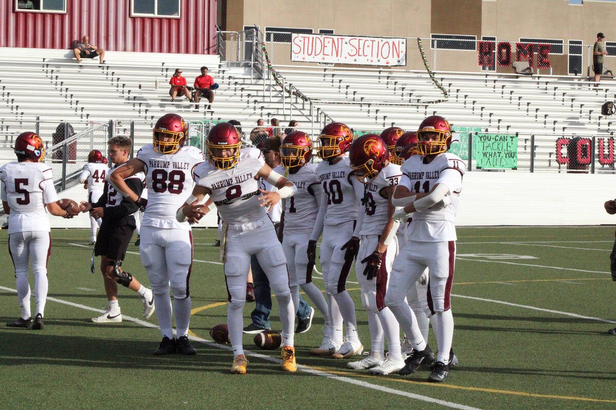 The Trojans offense has some fun before kicking off against Pinecrest Cadence Academy. (Jacob P ...