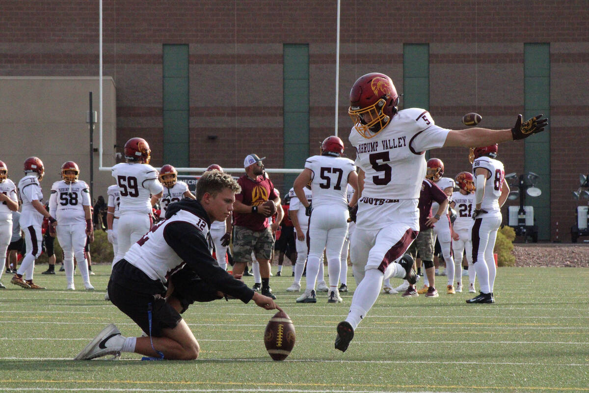 Trojans kicker junior Aaron Rily practices some pre-game point after field goal attempts in a r ...