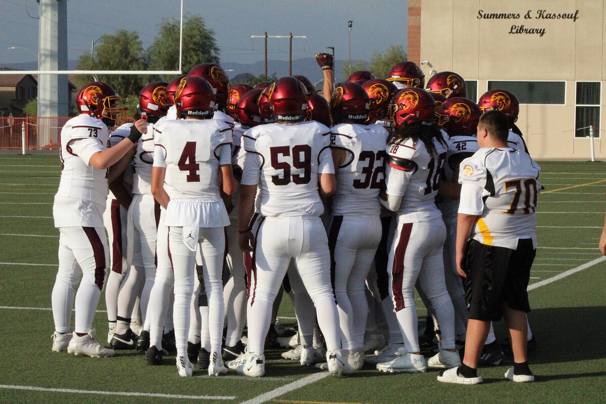 The Trojans get fired up in a huddle prior to the first game of the season against Pinecrest Ca ...