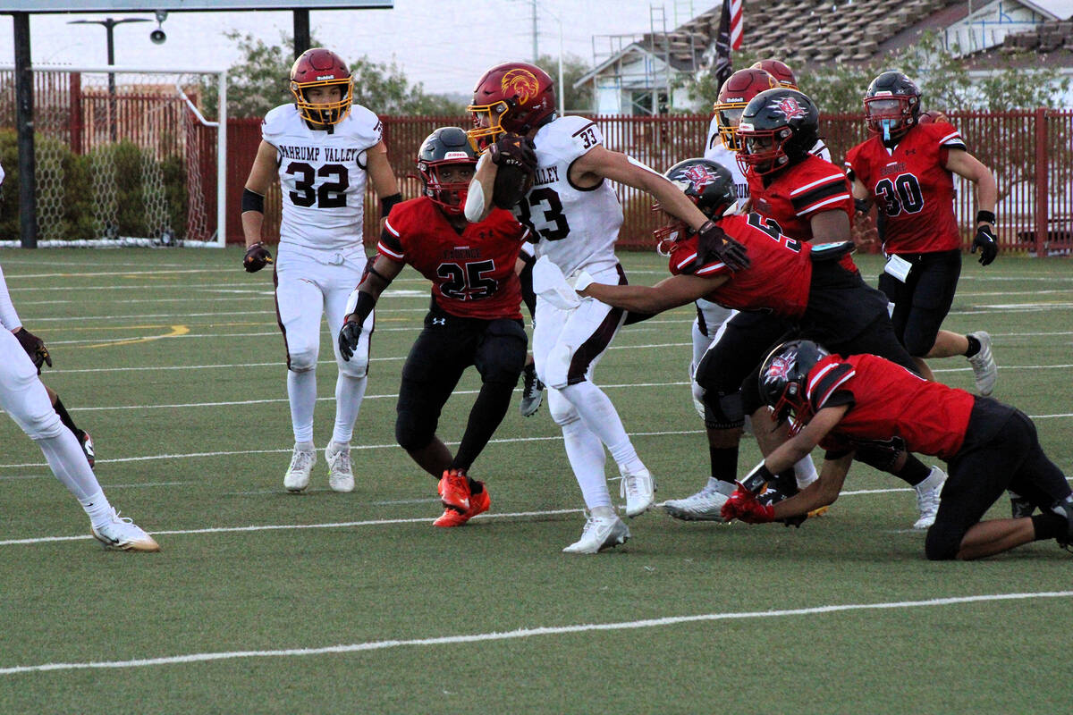 Trojans senior running back Austin Alvarez sheds multiple tackles for a positive gain against P ...