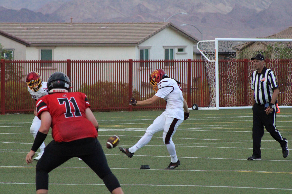 Kicker junior Aaron Rily kicks off with a nice squib kick to the right side of the field agains ...