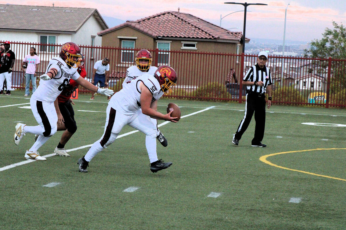 Following a blocked punt by senior Jack Walker, Trojans junior Preston Doctor goes for the scoo ...