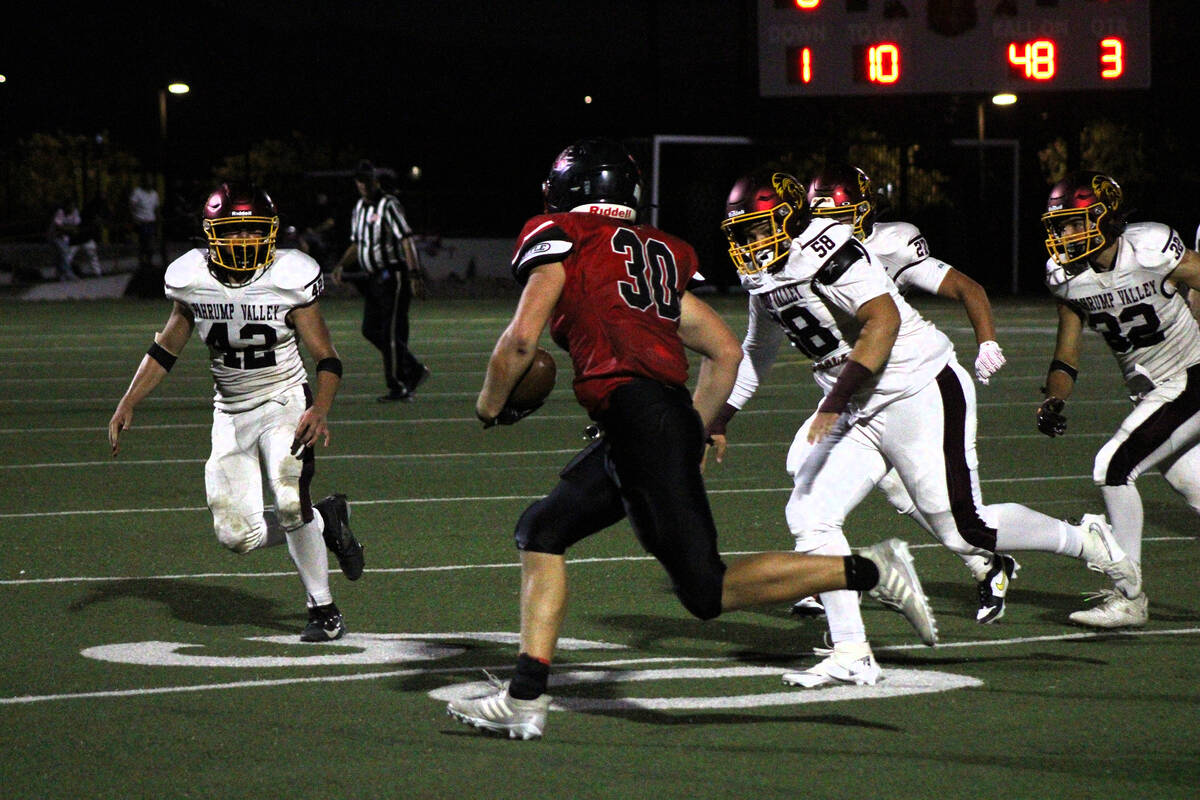 Trojans DL/OL junior Luca Blunda and junior safety Christian Ramiscal combine to stop the Couga ...