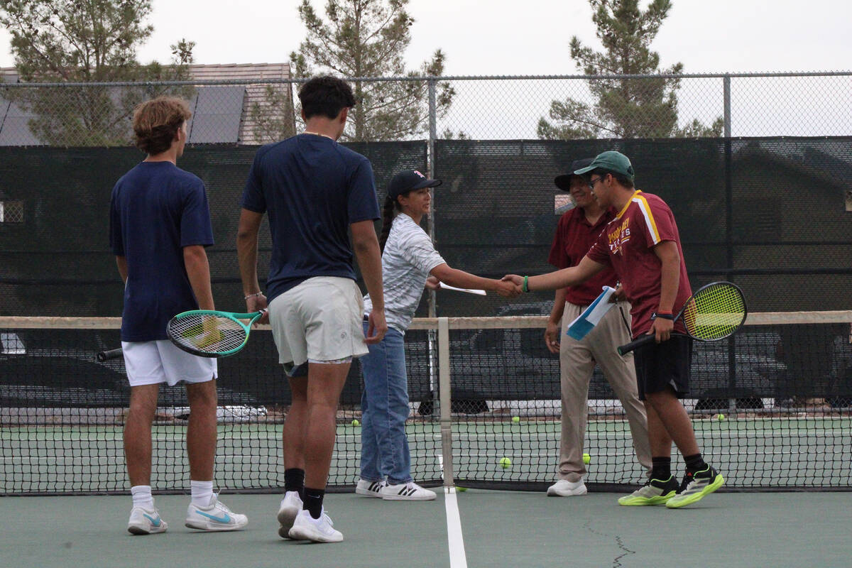 Pahrump Valley High School tennis junior Juan Carlos Rodriguez-Ortiz shakes Liberty High School ...