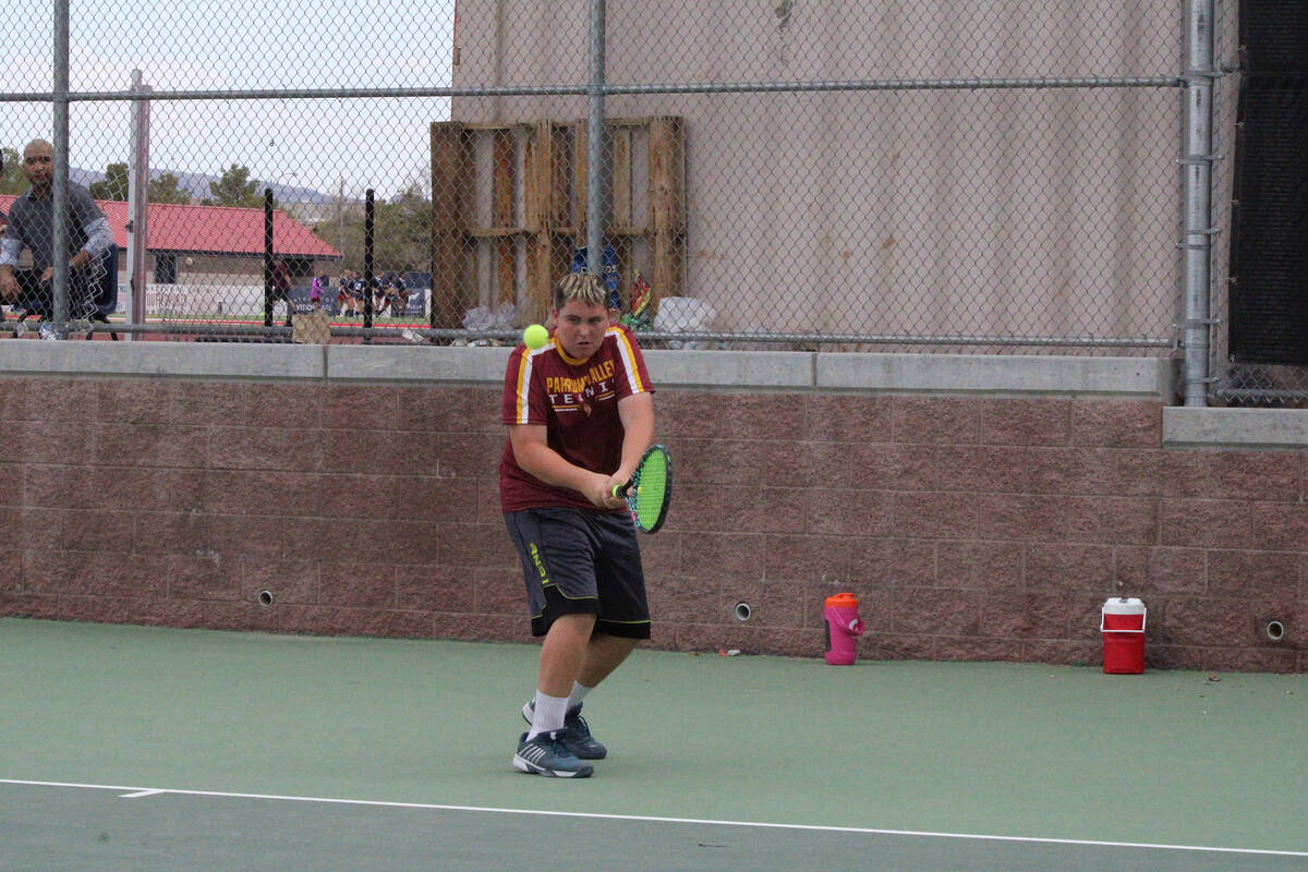 Pahrump Valley High School tennis senior Lucas Johnson returns a hard serve in a match against ...
