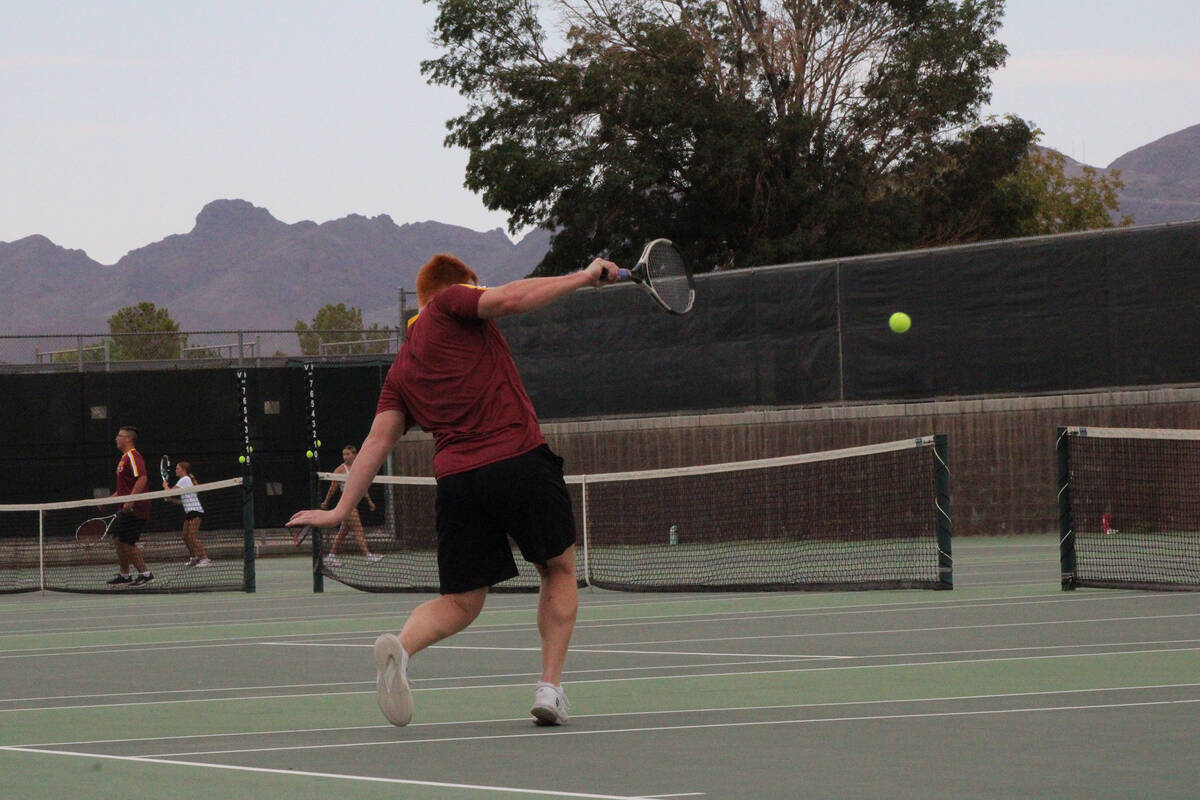 Pahrump Valley High School tennis senior Sonny Skinner follows through with a backhand during a ...