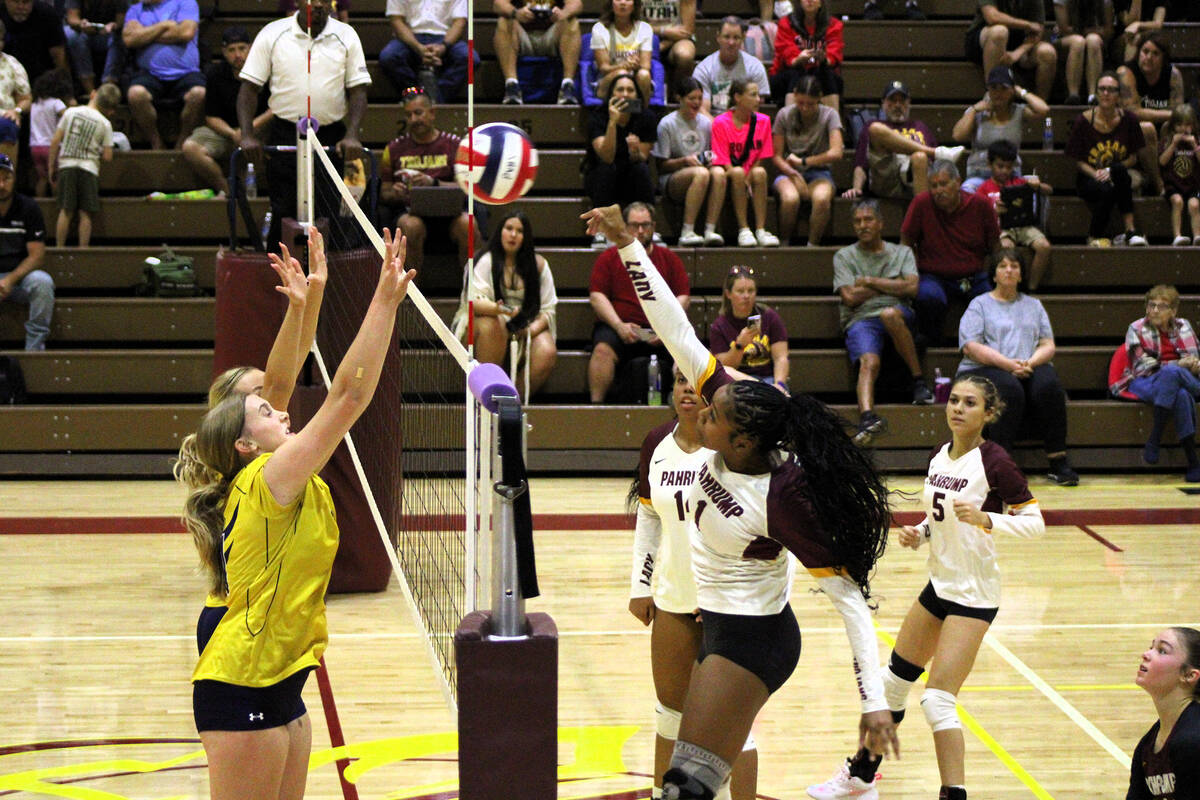 Lady Trojans senior #1 Heavenly Ware goes to make a kill on the ball against the Eagles defense ...