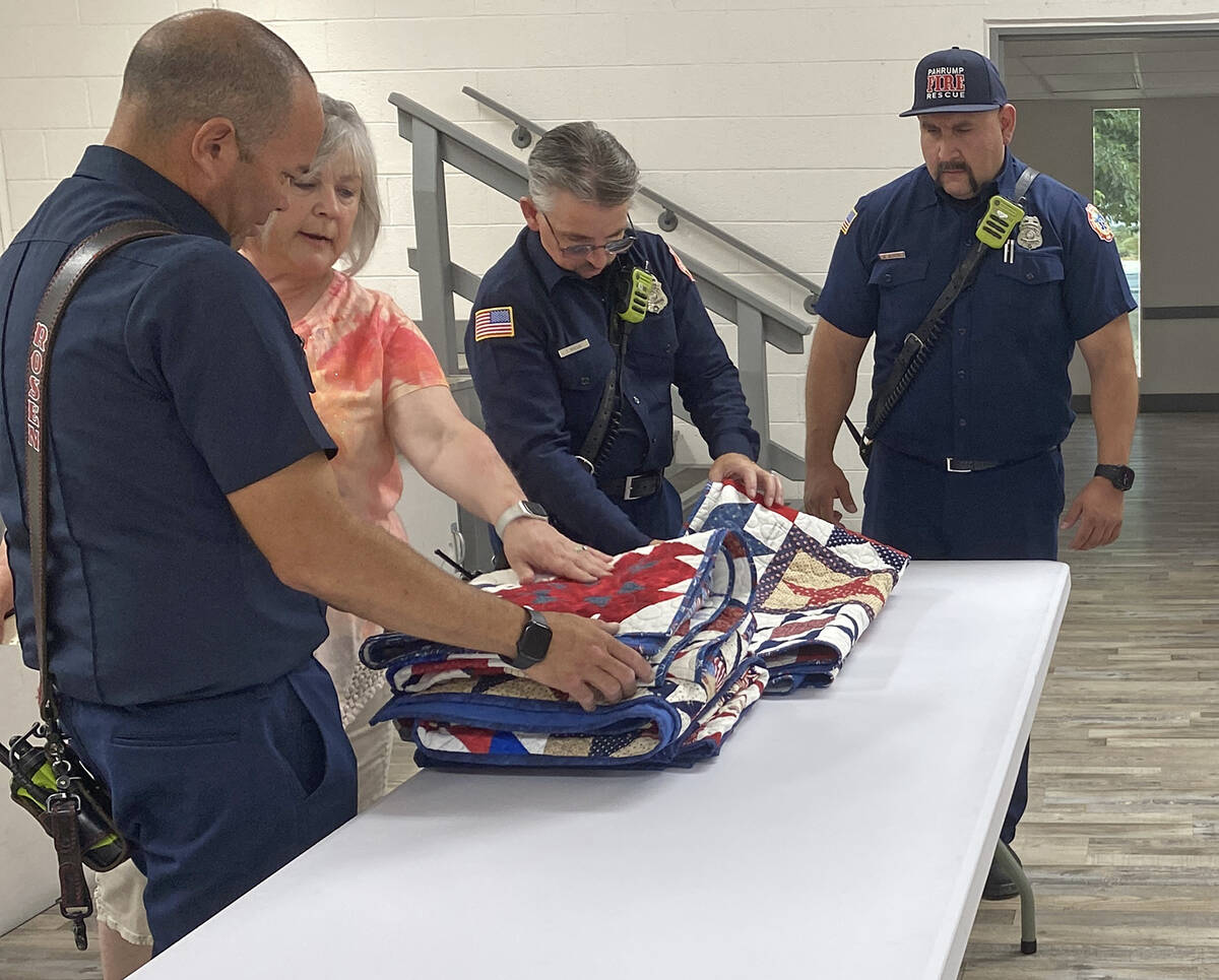 Shadow Mountain Quilter Janet Blethen points out the names that are written onto each of the pa ...