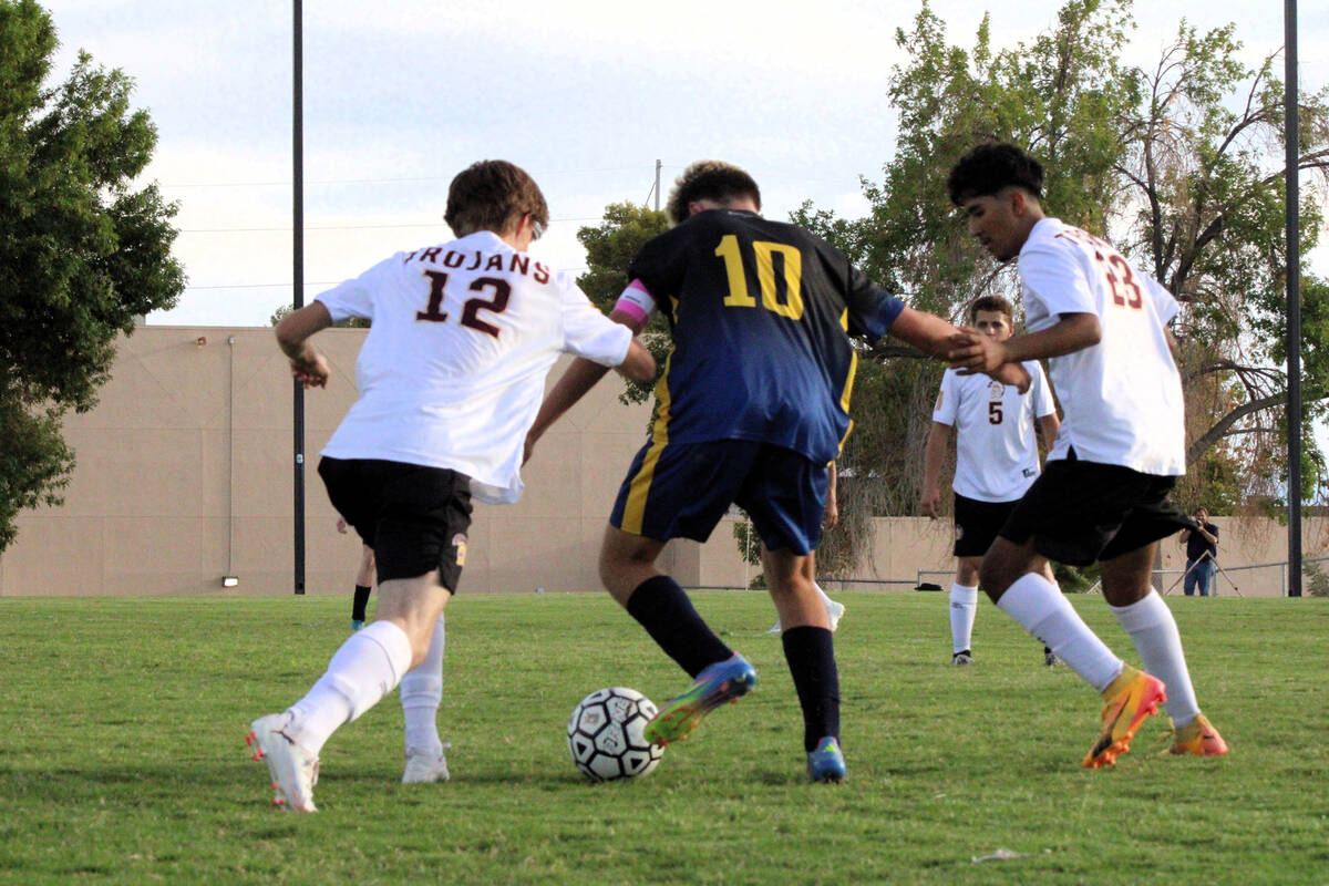 Pahrump Valley High School senior defender James Wilson and senior forward Favyan Sida tries to ...