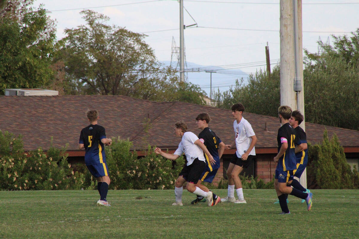 Trojans TC Hone and Samuel Mendoza get close into Boulder City's box as they try to push for mo ...