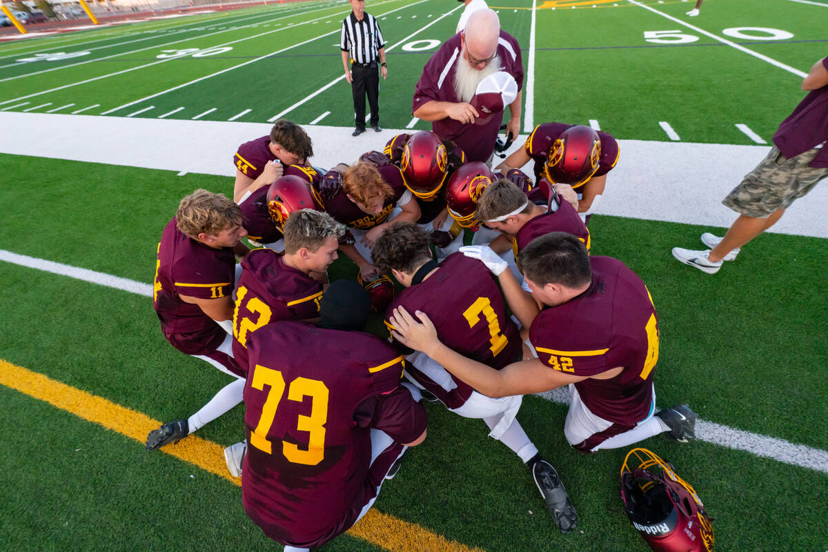The Trojans gather together for a team prayer before their first home game of the 2025 fall sea ...