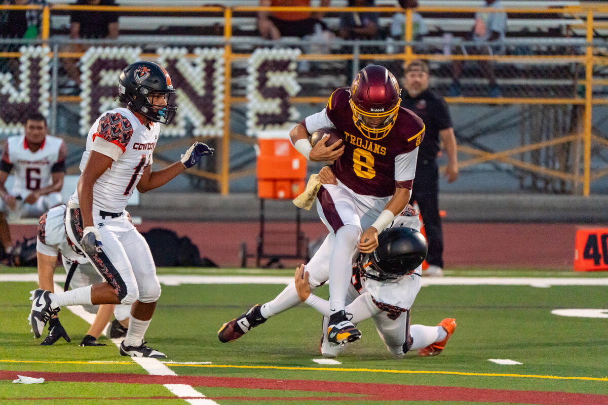 Pahrump Valley High School senior quarterback Kayne Horibe breaks a tackle against the Cowboys ...