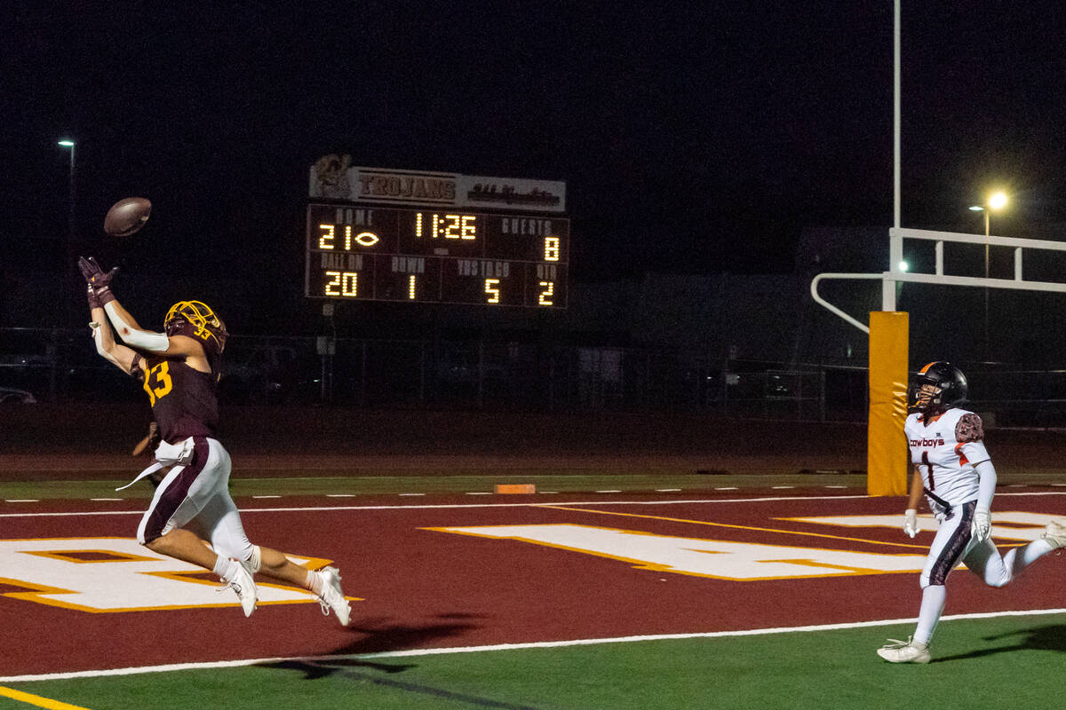 Pahrump Valley High School senior Austin Alvarez attempts to real in another touchdown pass aga ...
