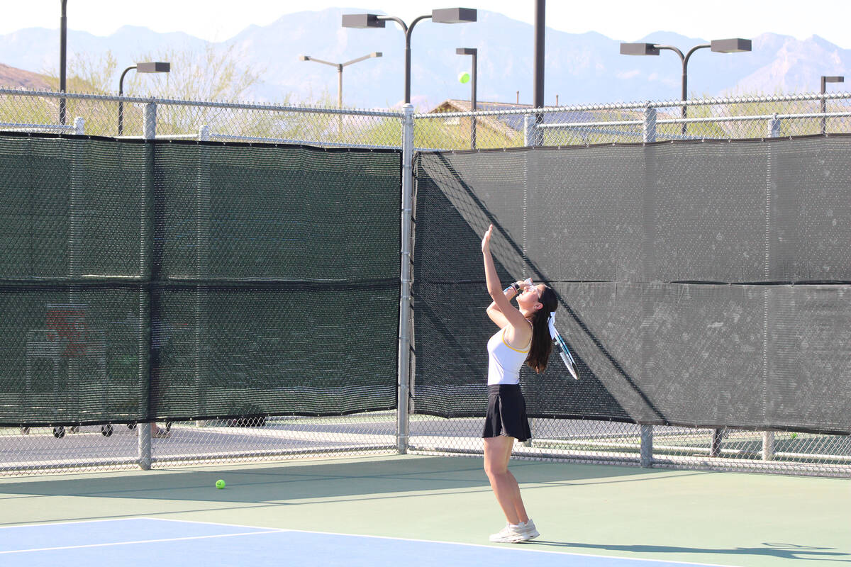 Pahrump Valley High School tennis junior Milly Khandpur prepares to make a serve in a match aga ...