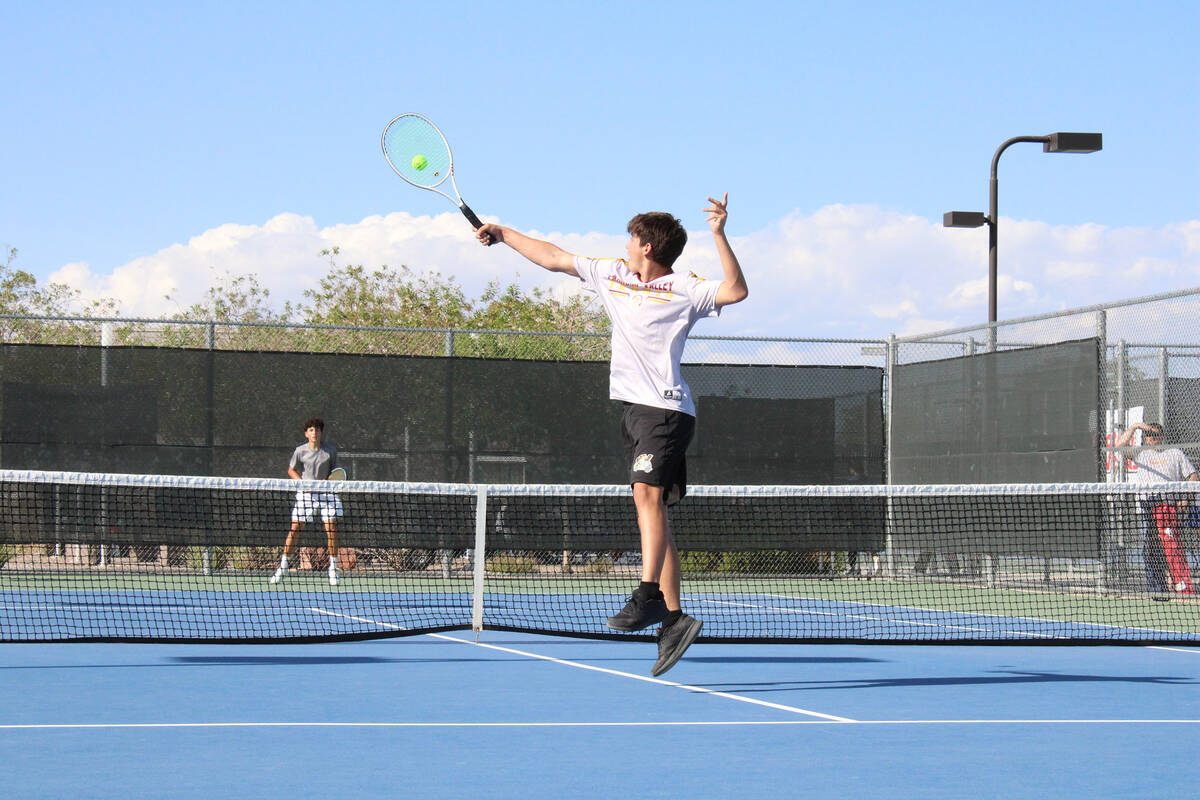 Pahrump Valley High School tennis sophomore Jace Eichner returns a hard serve in a singles matc ...