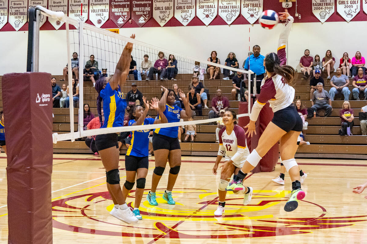 Pahrump Valley High School OH/RS Xe’anne Kamanu attempts to make a kill against the Democracy ...